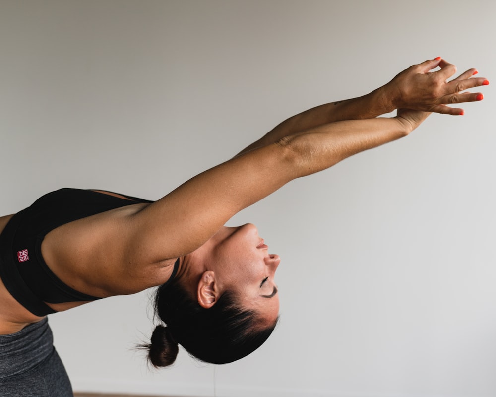Yoga students in downward dog position during class